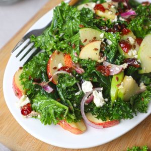 close up side shot of kale apple salad in a white platter