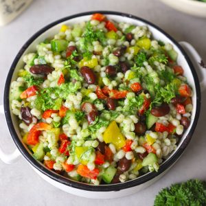 aerial shot of green barley salad in a white ceramic bowl
