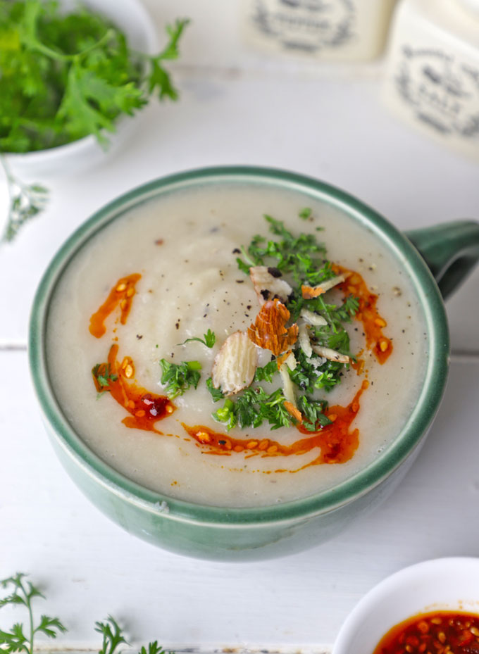 side shot of cauliflower soup in a green ceramic mug