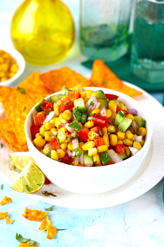 side shot of corn salsa in a white ceramic bowl