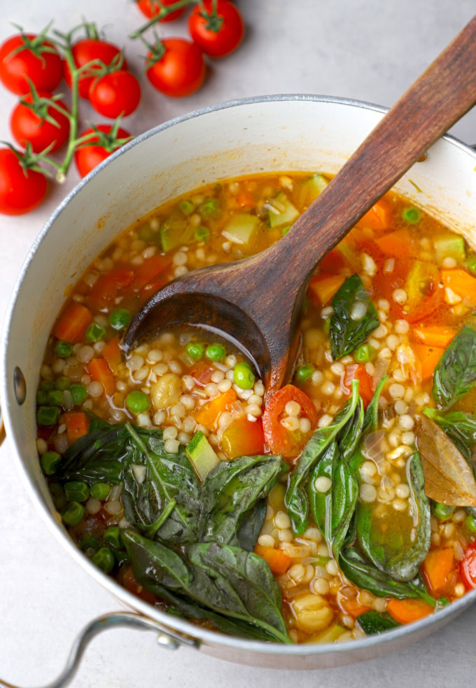 side close up shot of pearl couscous soup in a saucepot
