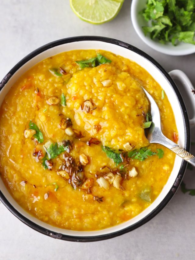 aerial shot of masoor dal in a white ceramic bowl with spoon
