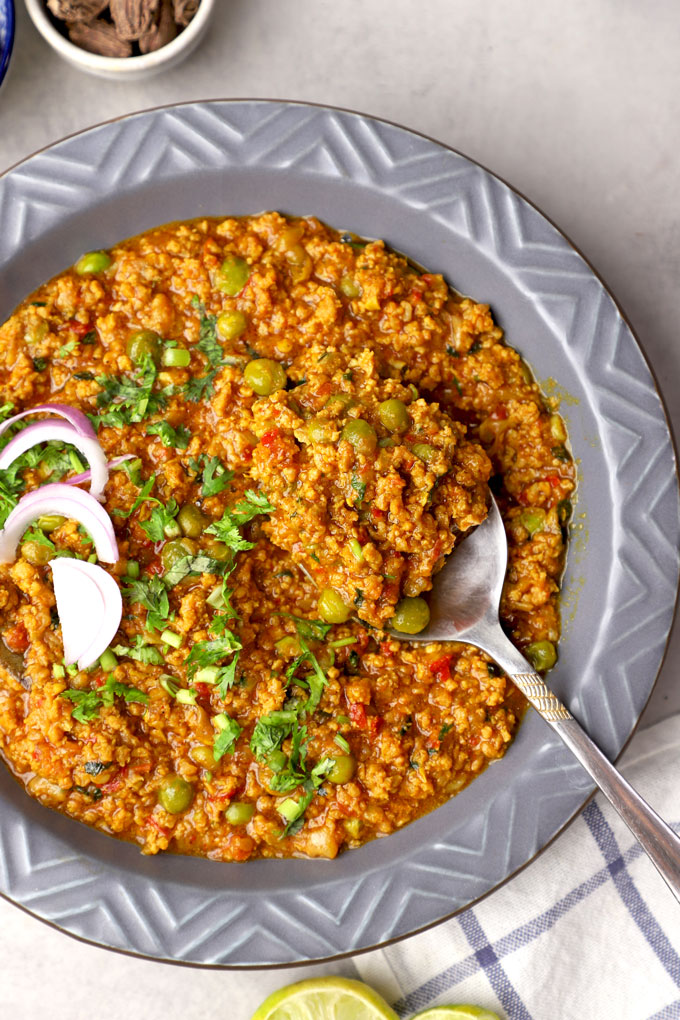 aerial shot of keema curry in a plate with spoon.