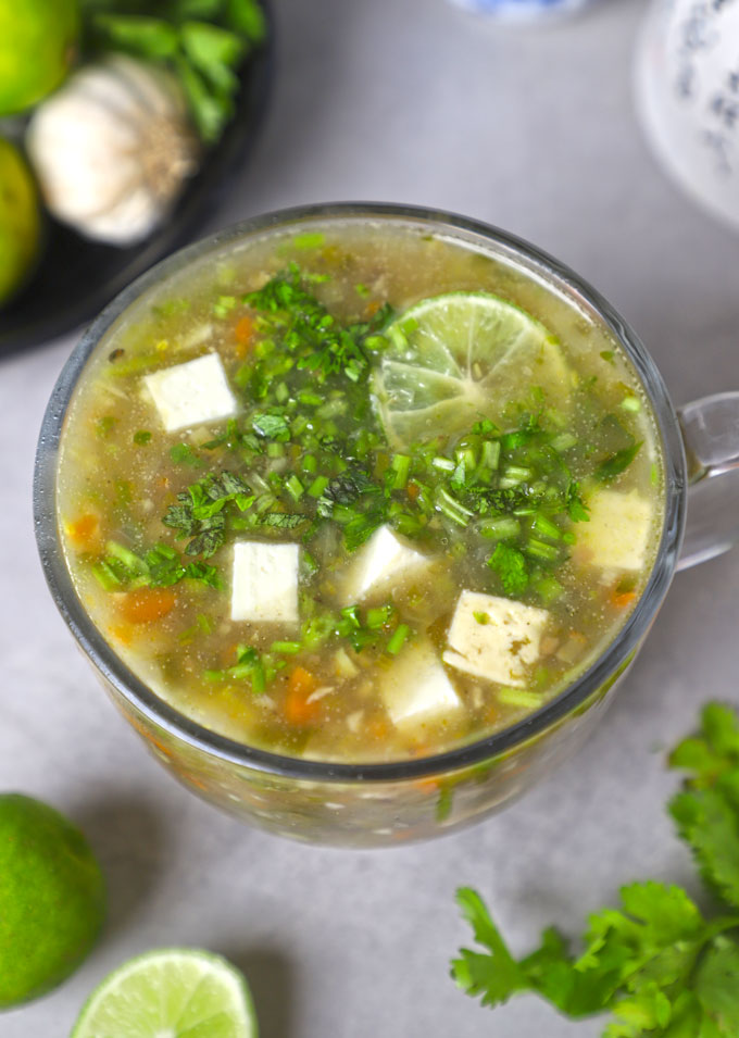 aerial shot of lemon coriander soup in a glass mug