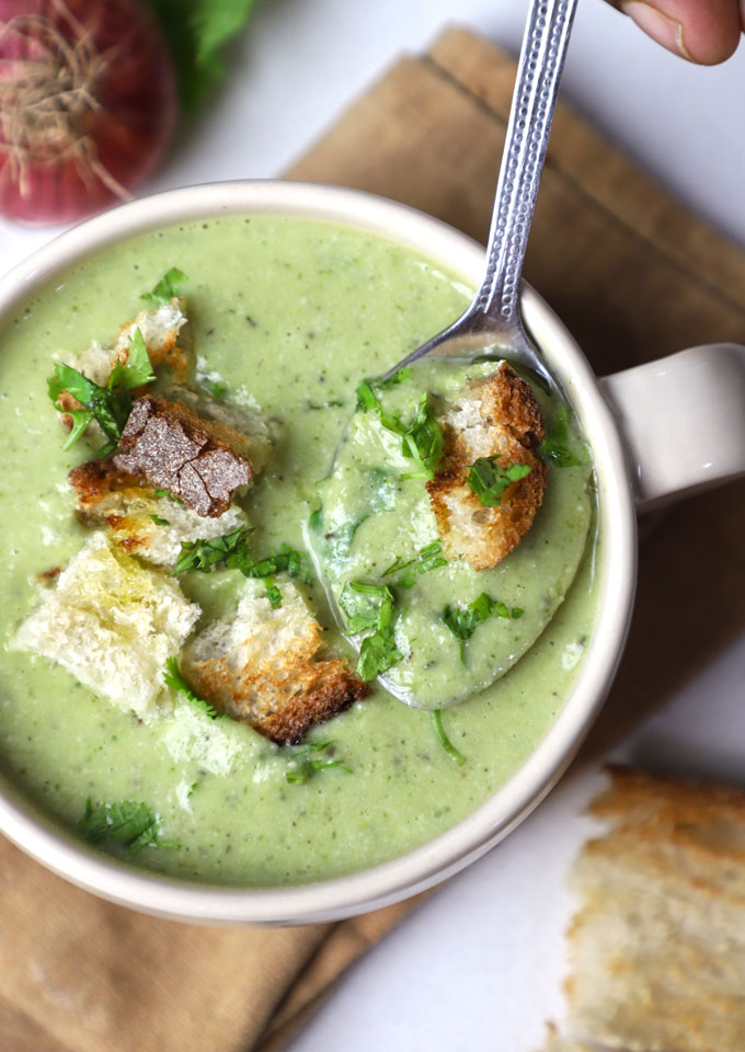 aerial close up shot of zucchini soup in a mug